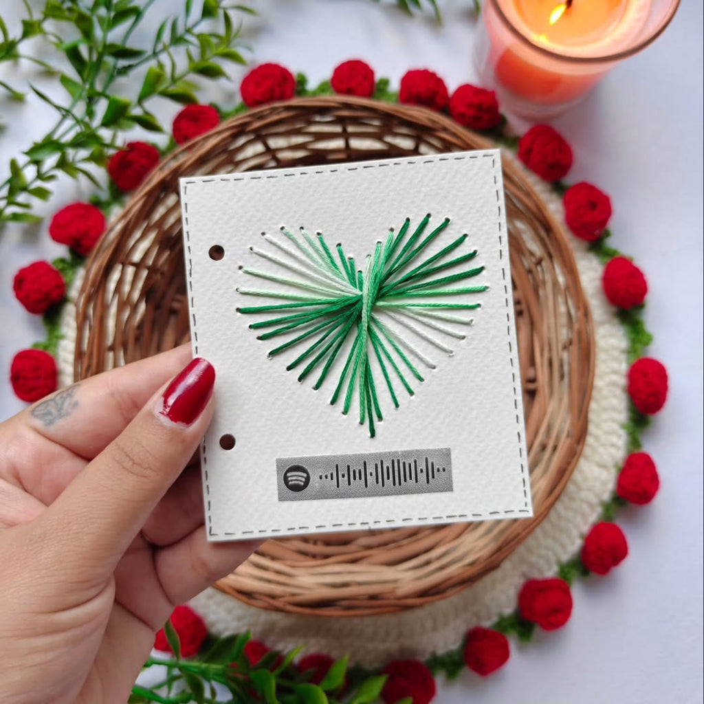 Hand-embroidered green heart thread art on premium white cardstock with a scannable Spotify music code