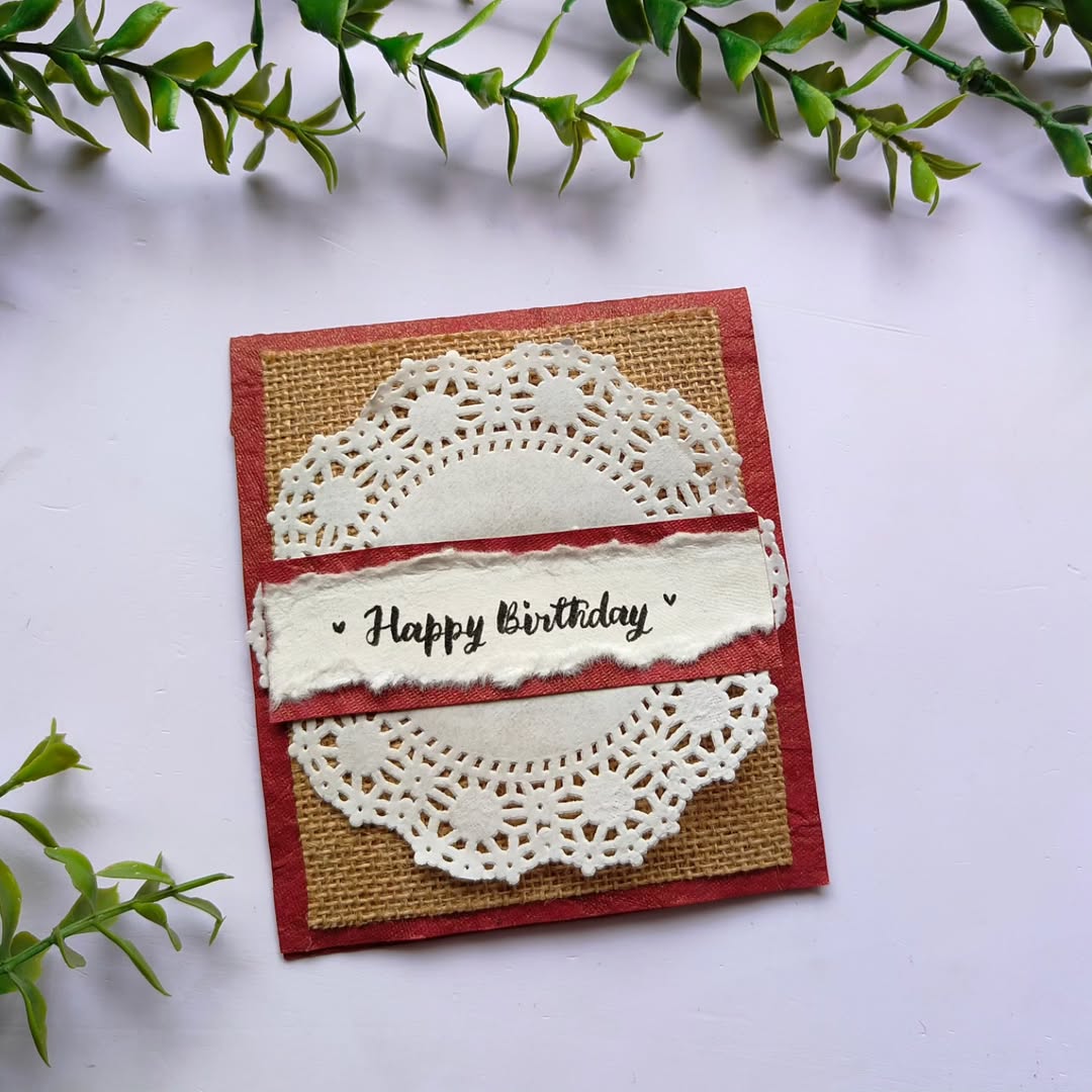Handmade birthday card with a red and jute rustic design, featuring creative paper layers and textures.
