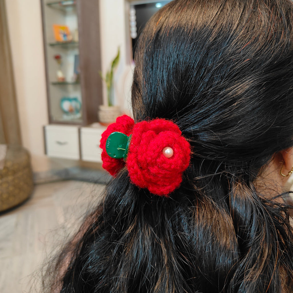Close-up of a red handmade crochet rose claw clip hair accessory by Art Cart by Swati.