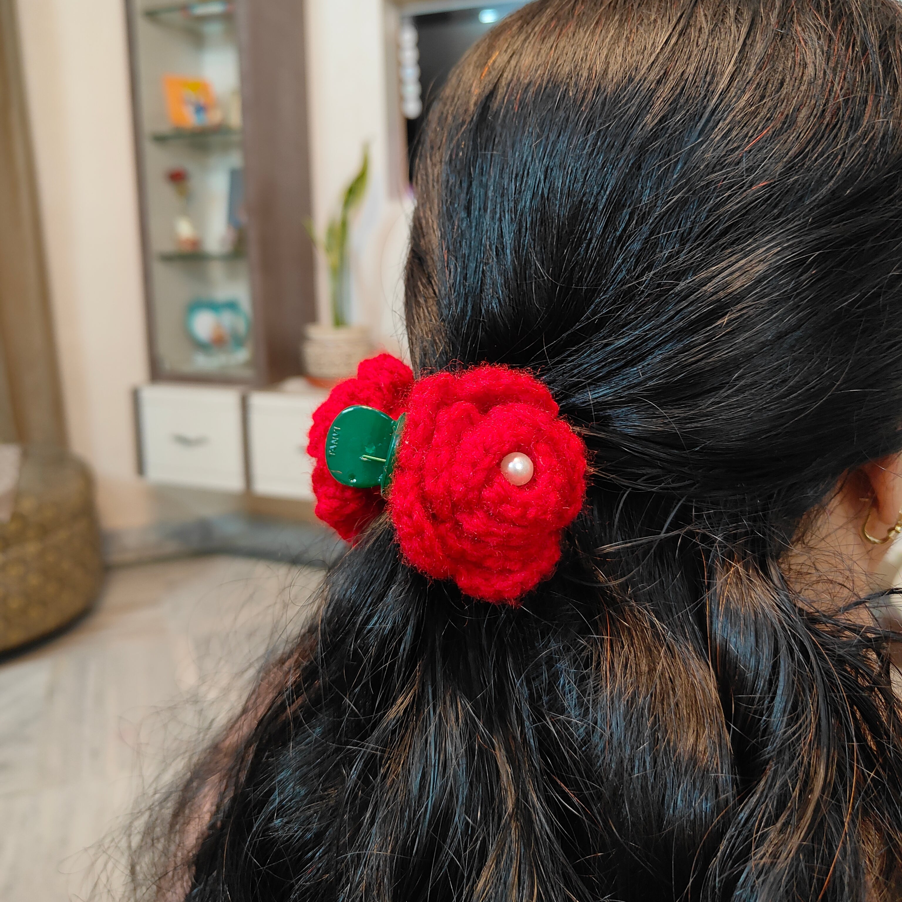 Close-up of a red handmade crochet rose claw clip hair accessory by Art Cart by Swati.