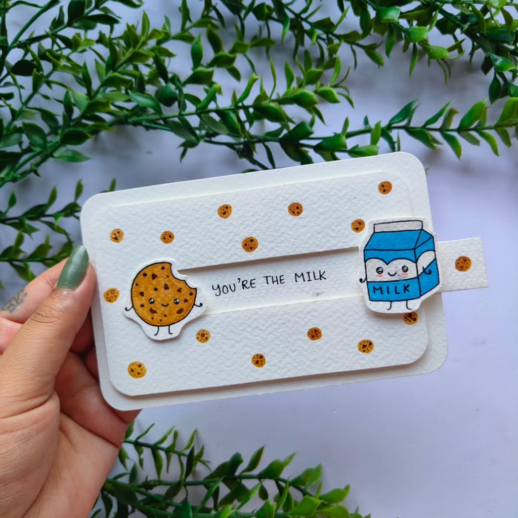 Handmade interactive slider card featuring hand-painted milk carton and cookie stickers on 300 GSM white cardstock.
